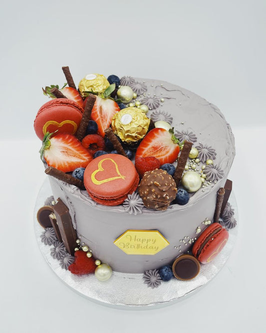 Silver cake with fruits and macaroons